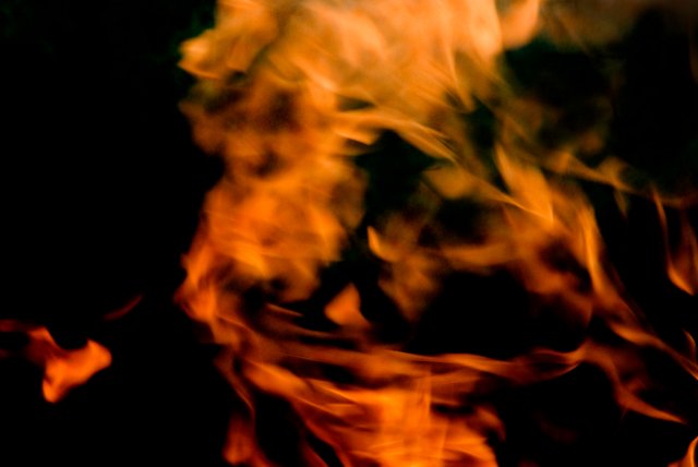 background of blurred burning flame on black