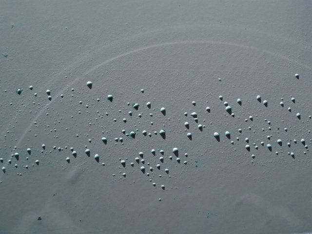 rust bubbles on a white pained surface
