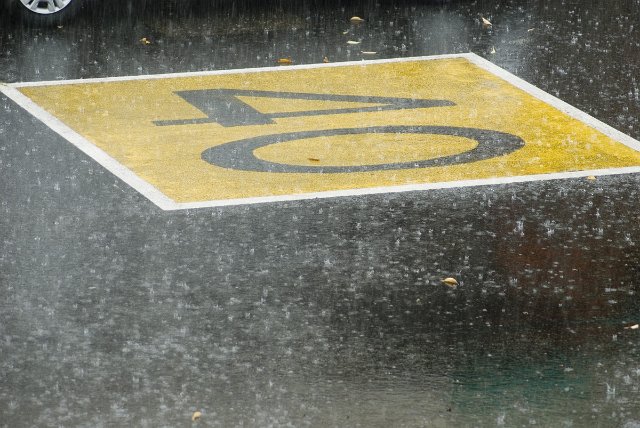 a rainy day on the roads - 40 speed limit painted on street