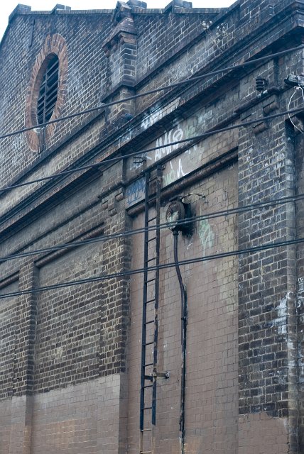 old brick building with ladder