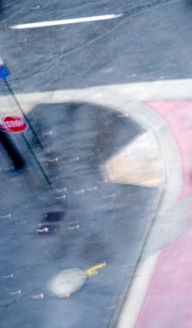 blurred abstract image of a stop sign at the end of a city street