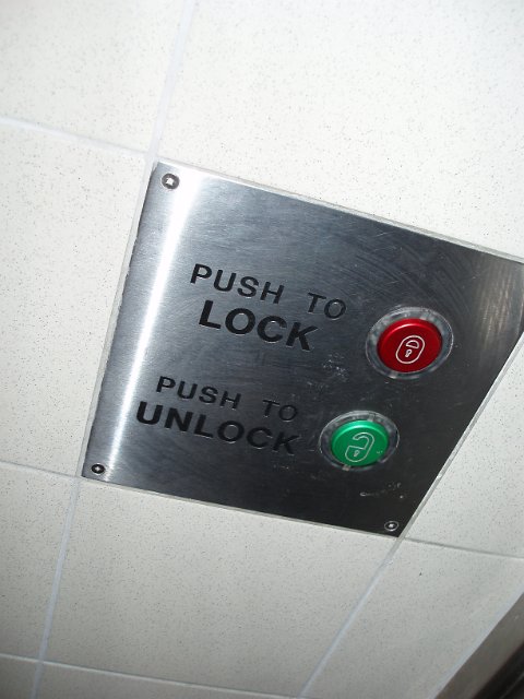 red and green buttons from a toilet door