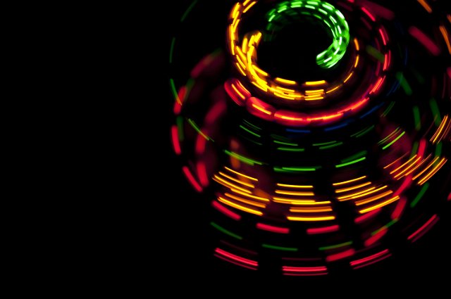 vividly colored dashed glowing lines creating  a circular rotating effect pattern