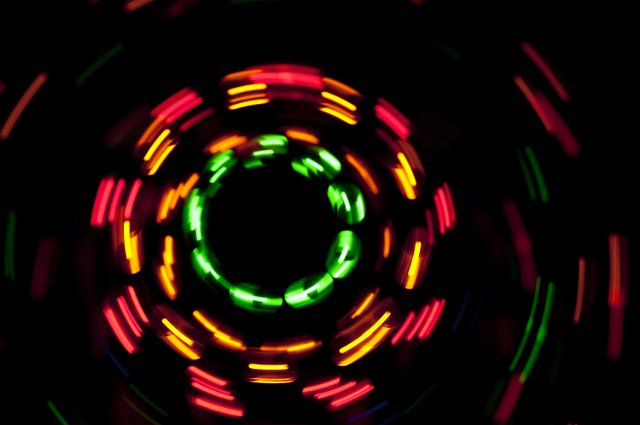 glowing dashes of light plotting concentric circles on a black background