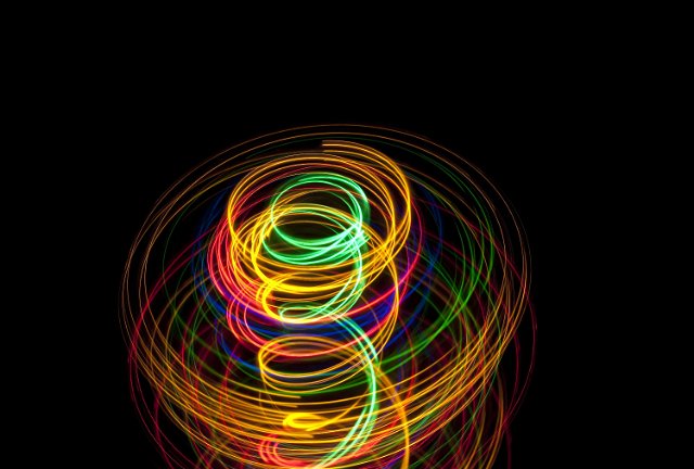 a vibrantly coloured spiral light effect with space for text