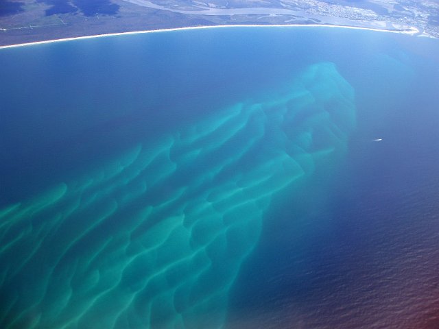 sandy shoal in a bay created by the tide and a river mouth
