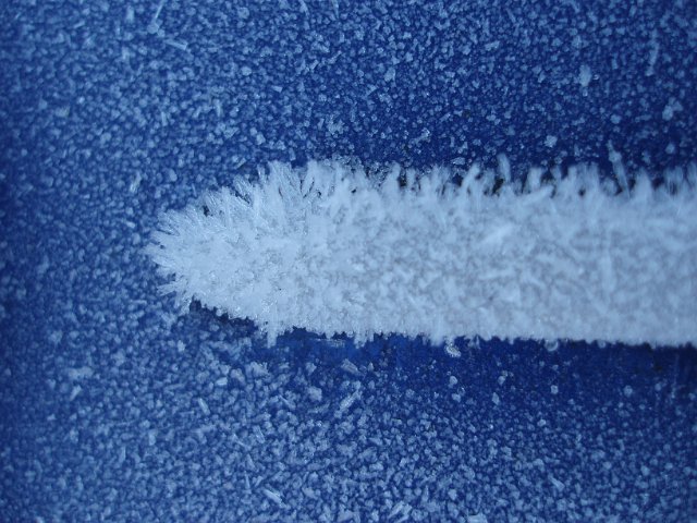 macro image of ice crystals growing on a car