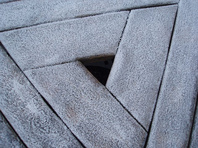 frost on a wooden triangle decking shape