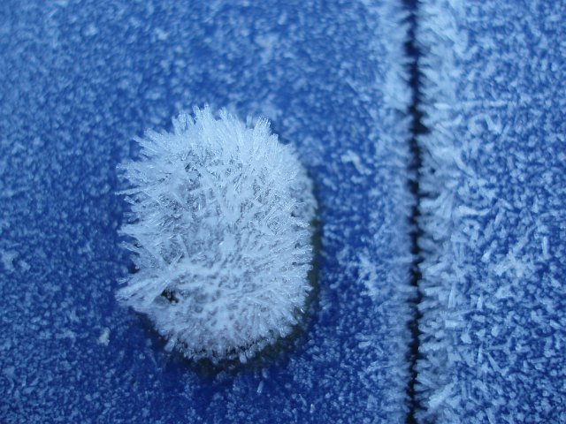 macro image of frost covering the body of a car