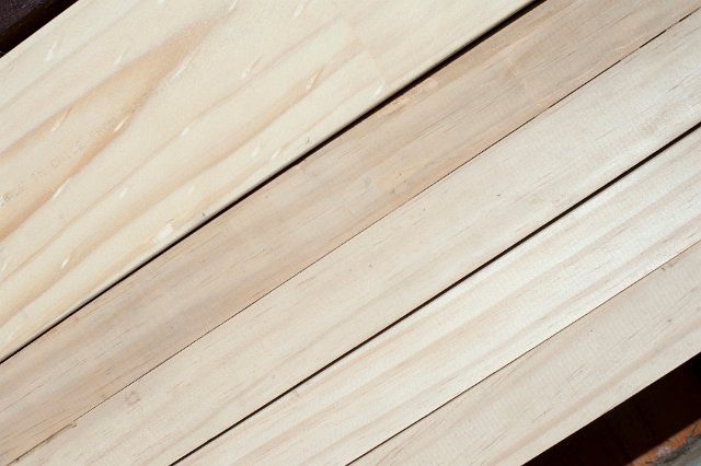 Loose natural pine planks for use as a building material in construction with a woodgrain pattern