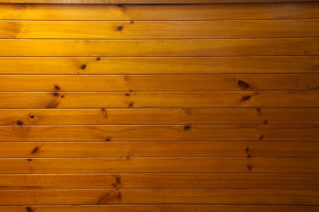 Background texture of tongue and groove wooden cladding running horizontally with a highlight on the left