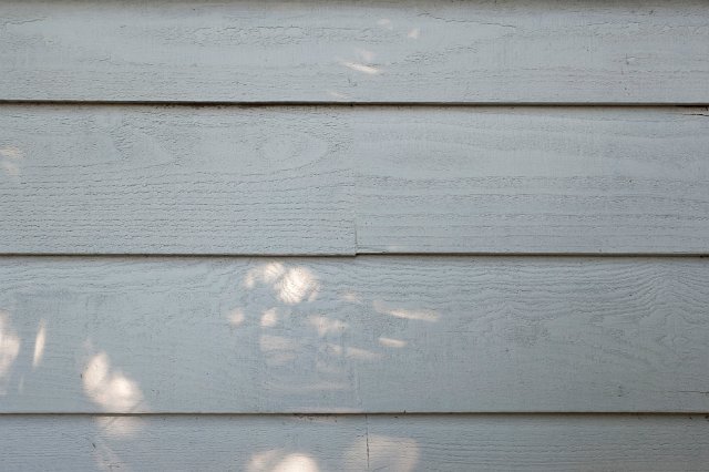 Old painted weatherboards or clapboards used as a cladding and construction material on the exterior of a building