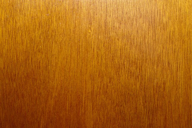 background of mid brown thight grained wood veneer