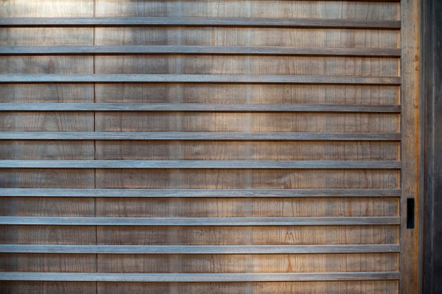 Background texture and pattern of thin parallel wood strips on an old wooden panel