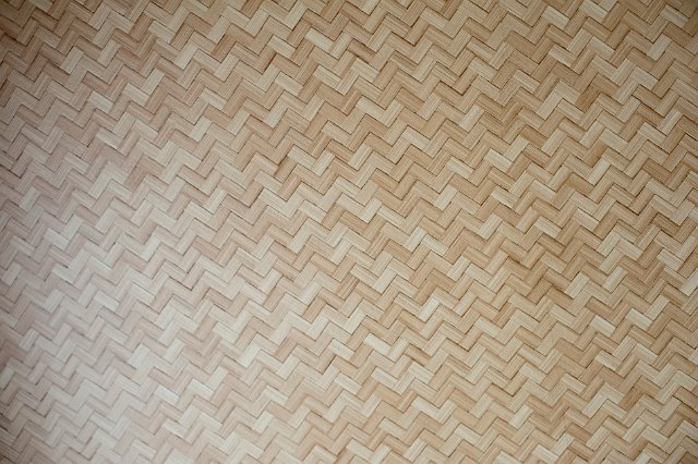 Background texture of woven bamboo used in construction with a repeat geometric zigzag pattern