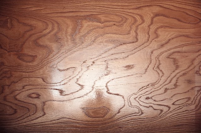 a reflective laminate of wood sliced at a shallow angle to elongate the growth patterns