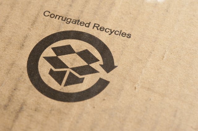 Recycled sign stamped on a cardboard packaging box or carton with the text - Corrugated Recycles - in an environmental concept