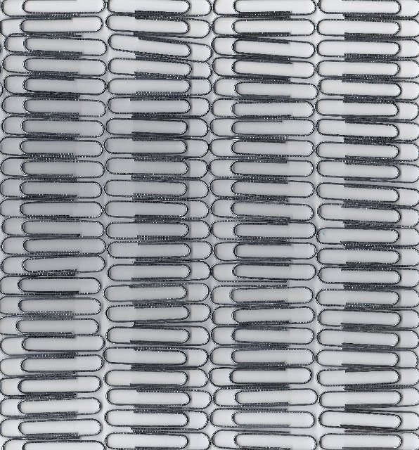 scanned metal paper clips arranged into lines on a white background