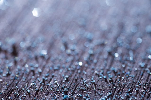 Rough texture with cold blue sparkle in a shallow dof view with blur and copy space