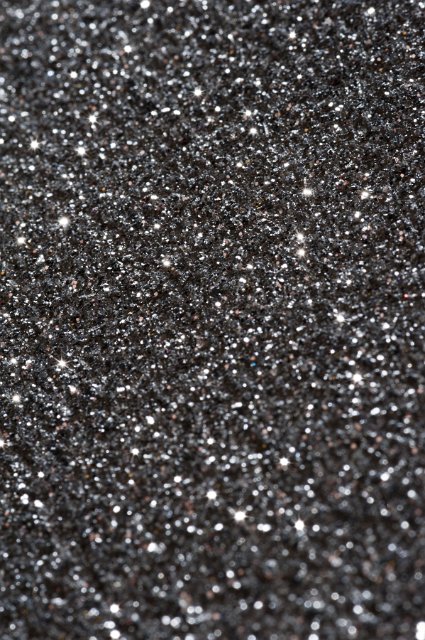 a black glitter blackground with sparking highlights