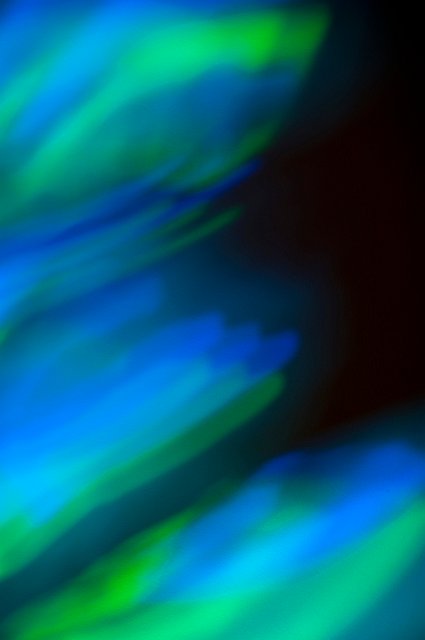 a blue and green flame like efffect made with light