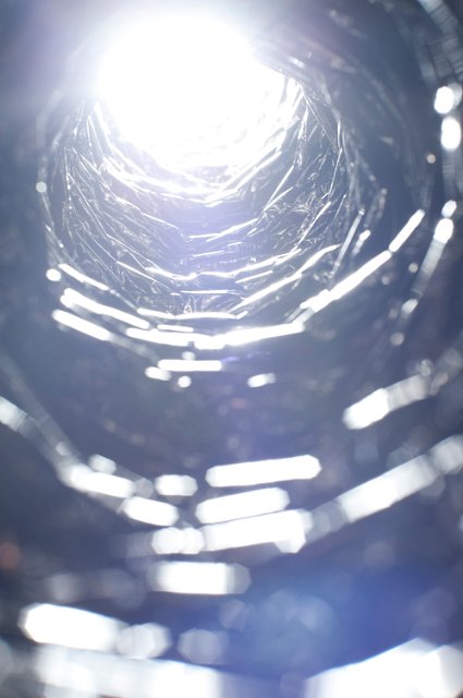 a dazzling bright white light at the end of a tunnel