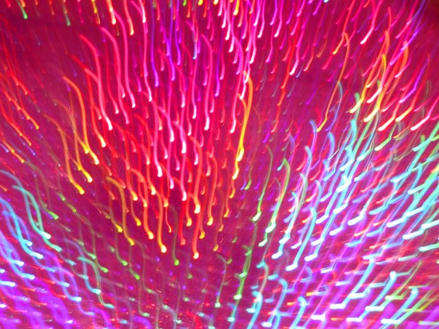 short curved squiggles of light created through motion blur photography