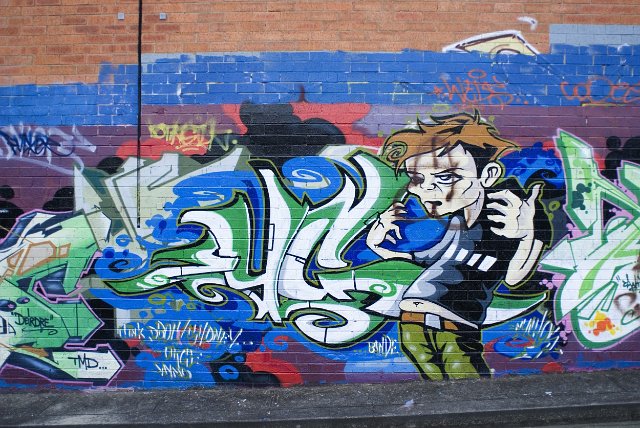Graffiti artwork characterture on a brick wall