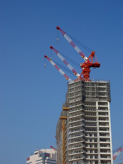 cranes on top of a building under construction in tokyo japan