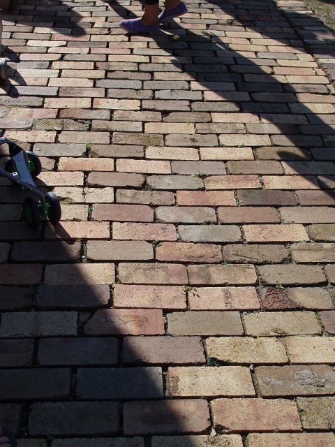 shadows of people on brick