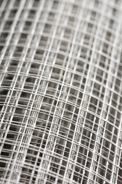 Role of steel mesh fencing wire in close up with shallow dof in a full frame background texture