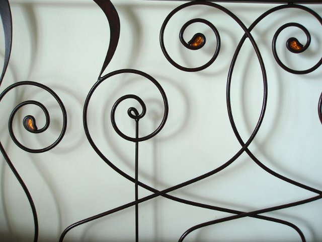 arabesque metal shapes with arching curves and inlaid glass