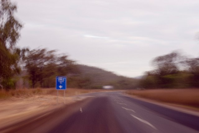 surreal blur on a long drive - blue road sign