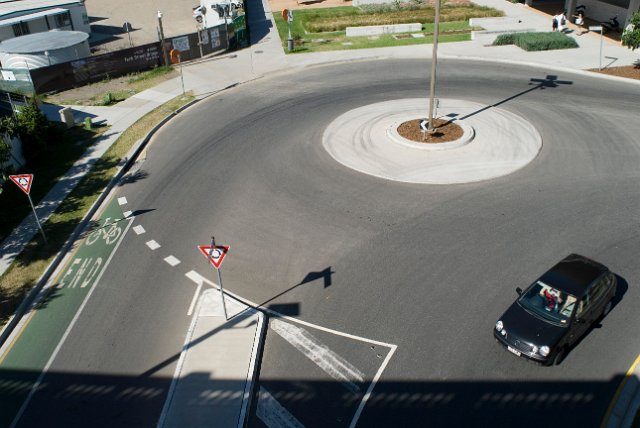 a roundabout from adove with a car turning off