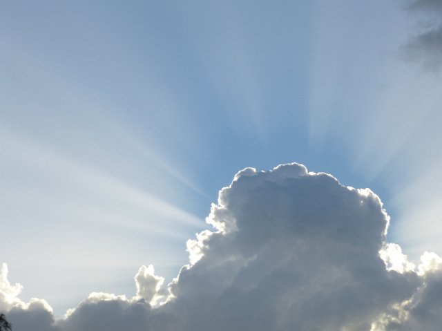 beams of sunlight from behind a cloud