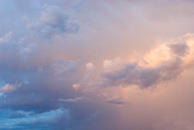 a pretty background of clouds illuminated with pink sunlight at dawn