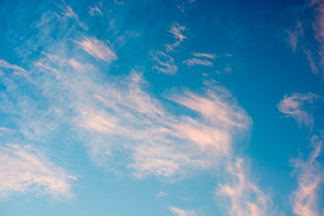 high altitude clouds lit with pink sunset light