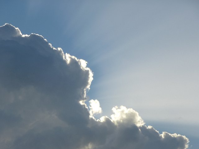 edge of a cloud brightly lit by the sun hidden behind
