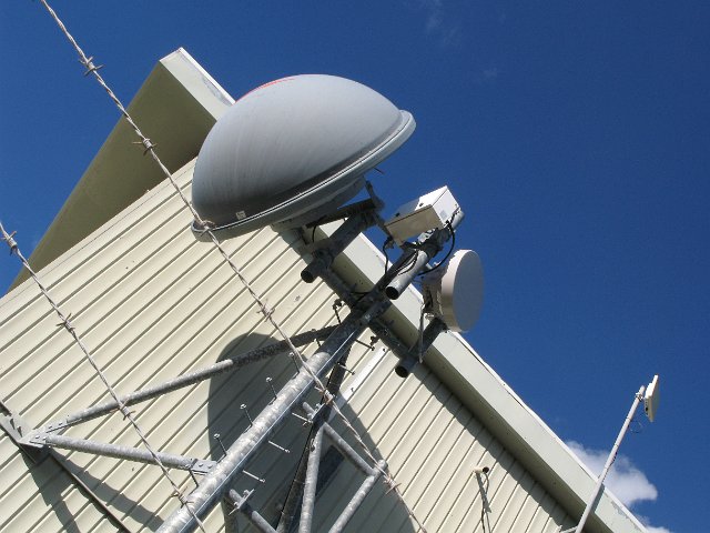 microwave antenna dish mounted on a mobile phone base station