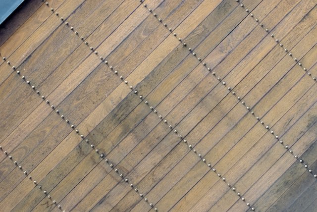 texture of a wooden surface with lines of screws