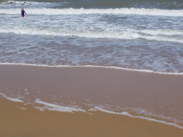 surf breaking on a sandy beach